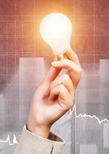 Picture showing low energy lightbulb being held by an energy manager.