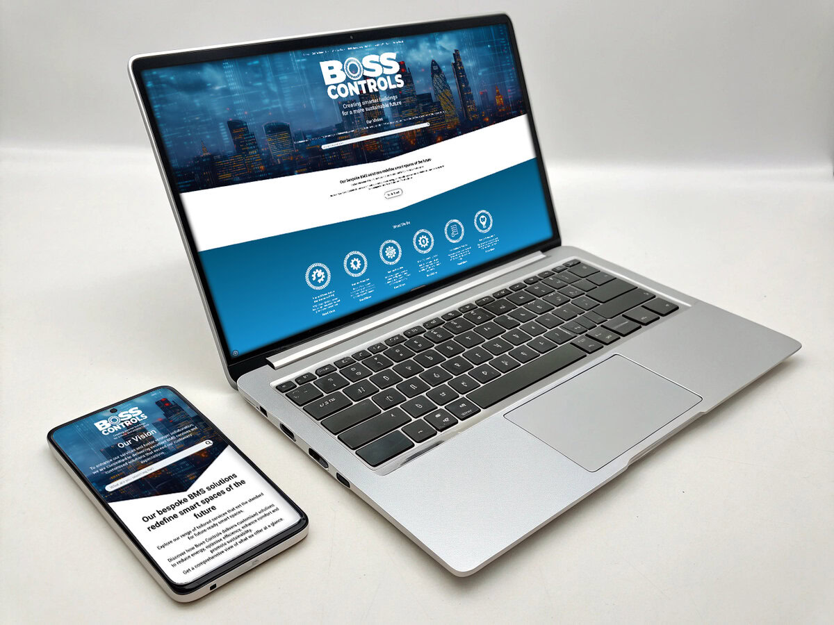 A laptop and smartphone displaying the Boss Controls website on a white background. The website features a cityscape with digital overlays, a bold header reading 'Boss Controls, and sections highlighting services related to smart building solutions. The design is responsive, clean, and professional.