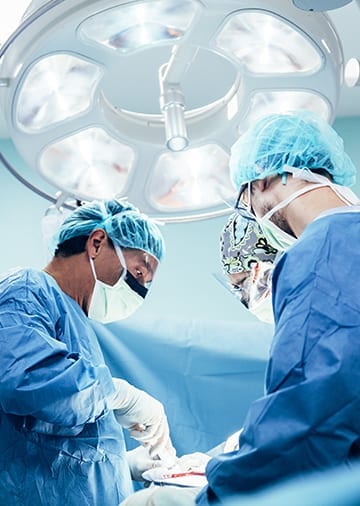 Surgeons in operating theatre – Boss Controls supports NHS and private healthcare with energy-efficient BMS to cut carbon and costs