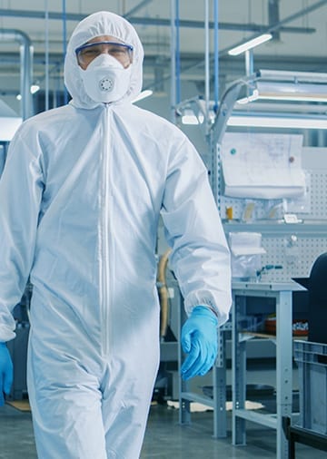 Engineer in sterile cleanroom suit – Boss Controls supports pharmaceutical environments with precise BMS control for hygiene and safety